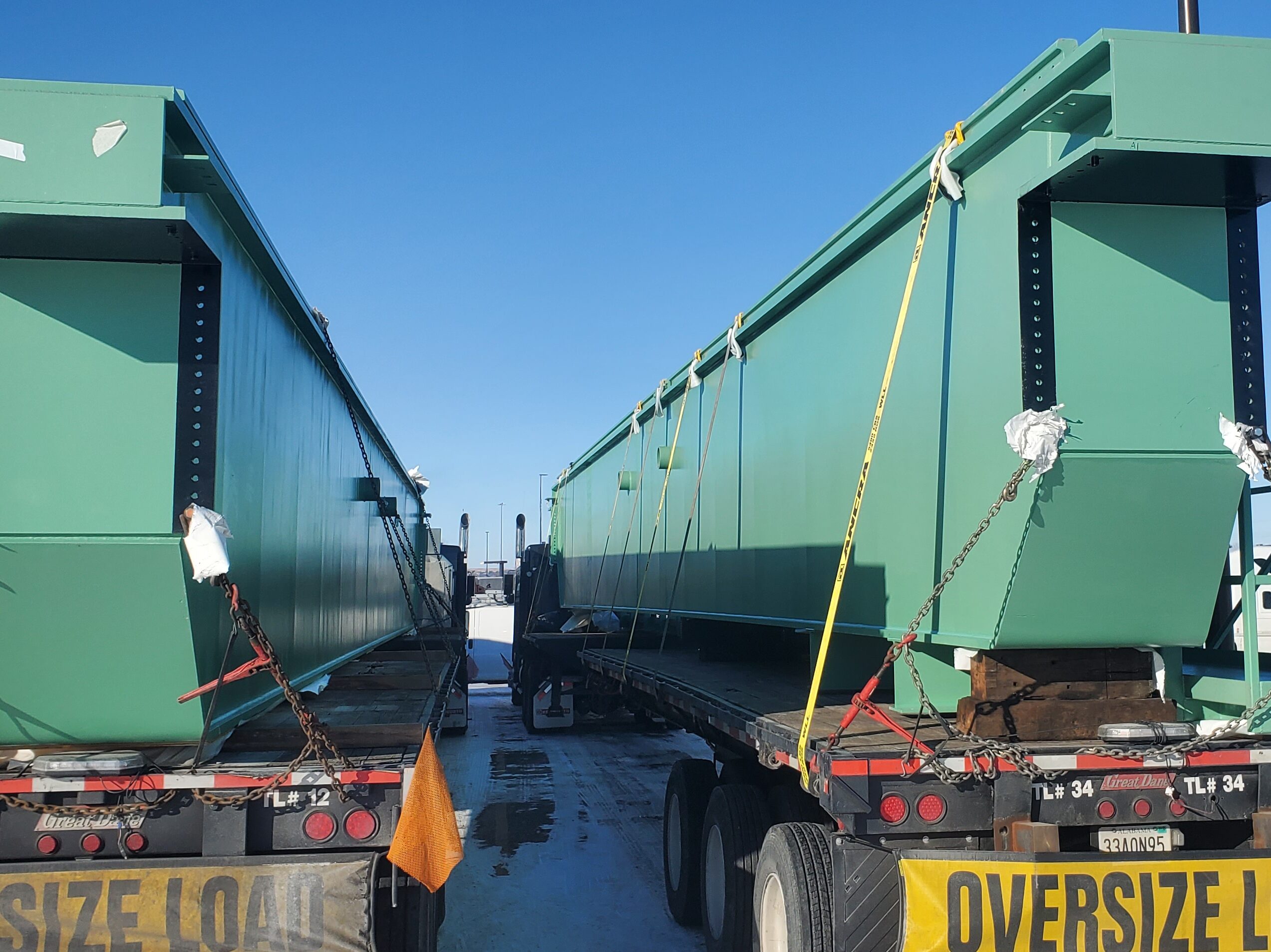two bridge crane girders needing to be Shrink-Wrapped before heading any further down the highway. We had the opportunity to lend a helping hand to get them recovered--due to time constraints we tarped them--and on their way to Grand Coulee, WA, where they would be installed in the hydro facility there. The girders are manufactured by G&G Steel of Russellville, AL and were delivered to BCI Construction USA, Inc. at the US Bureau of Reclamation, Grand Coulee, WA, site.